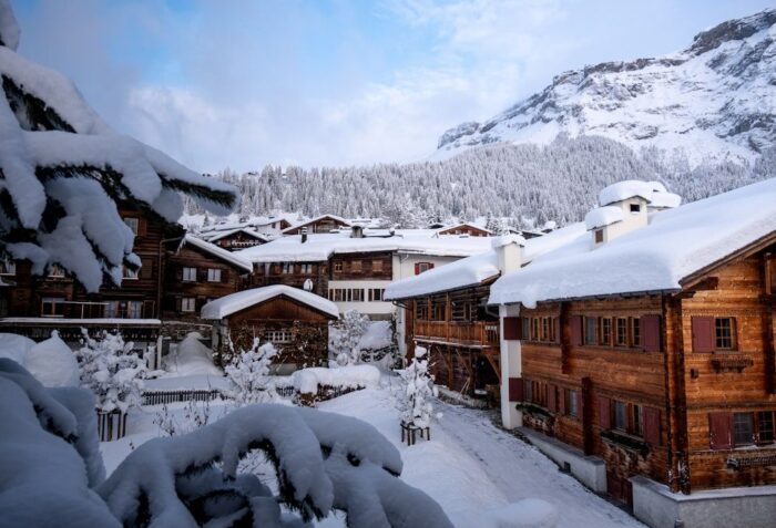 Snow-covered wooden chalets in a scenic Swiss mountain village