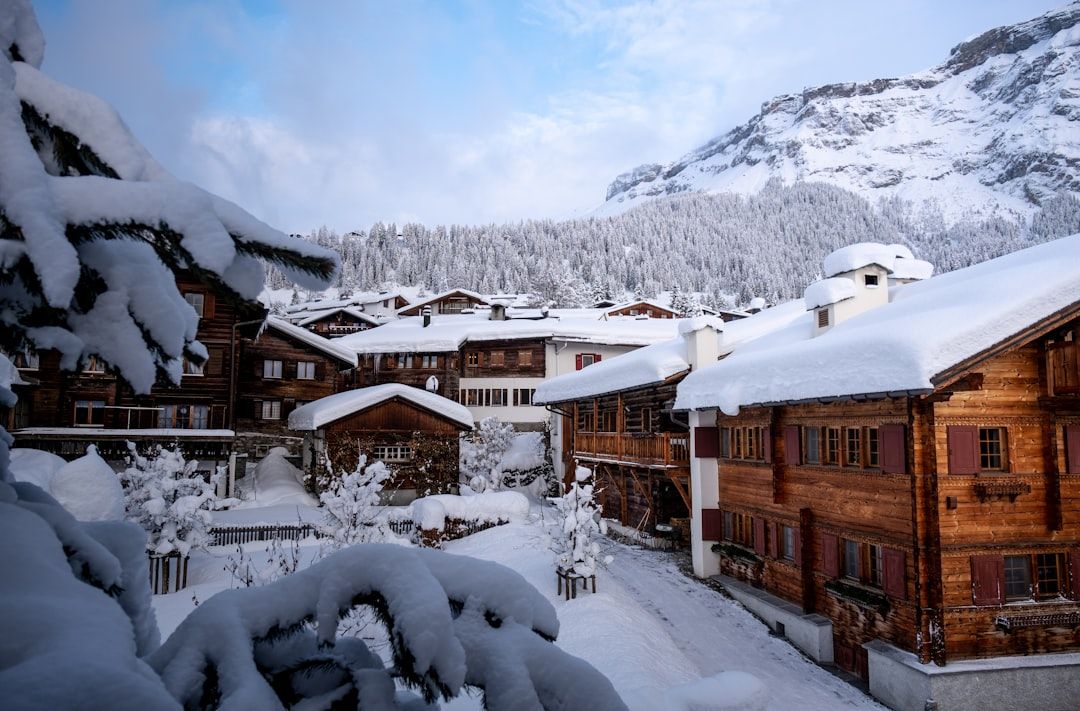 Snow-covered wooden chalets in a scenic Swiss mountain village
